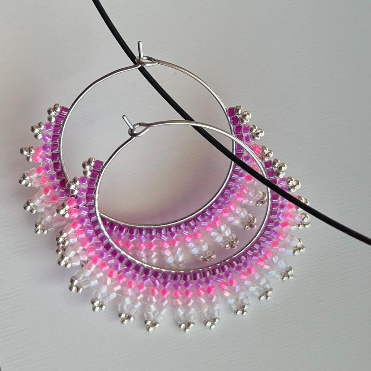 Handmade crescent moon hoop earrings in pink and silver colors, lightweight stainless steel earrings with Miyuki Delica beads