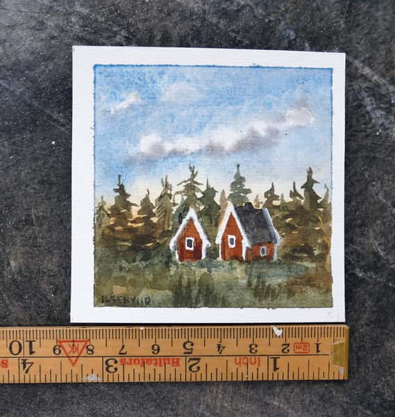 Liten original akvarellmålning. Röda stugor i skogen.