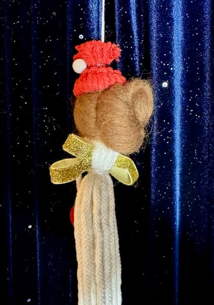 Handgjord julängel i flätat snöre med rött hjärta – brun hår i knut med röd mössa och vit tofs