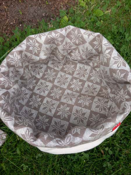 Fin brödkorg i beige bolstertyg och vit utsida.